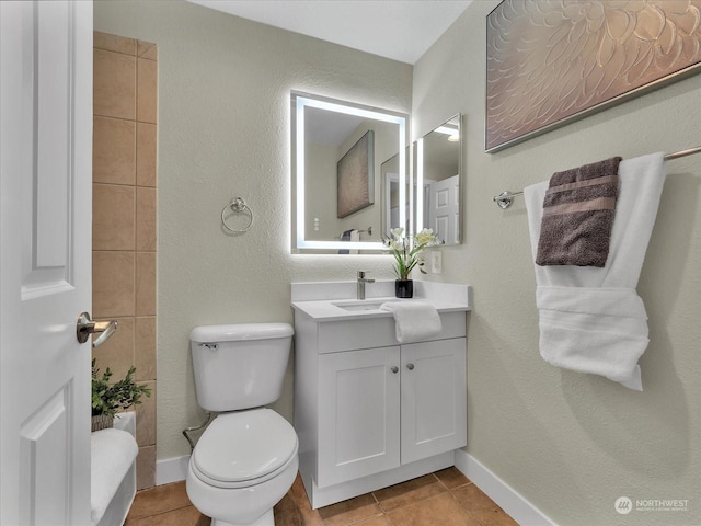 bathroom featuring tile patterned flooring, vanity, and toilet