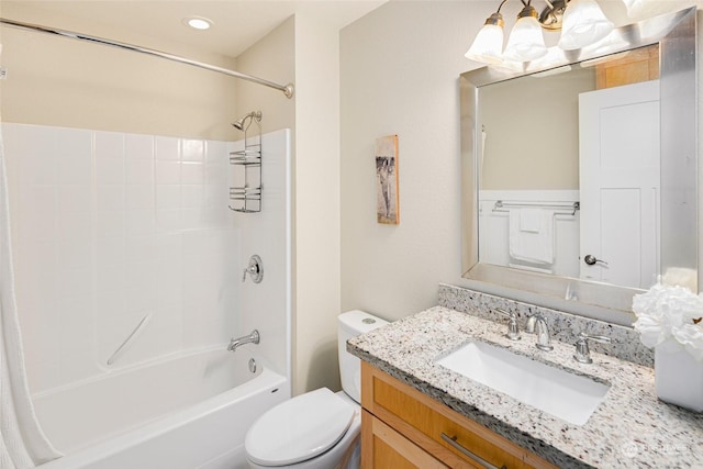 full bathroom featuring toilet, vanity, and tub / shower combination