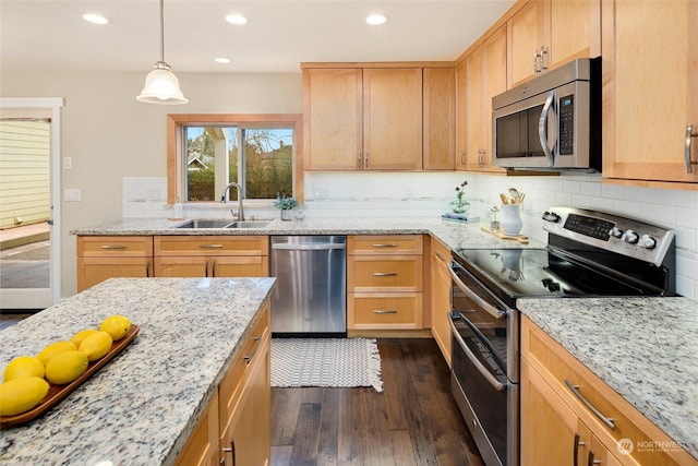 kitchen featuring appliances with stainless steel finishes, decorative backsplash, dark hardwood / wood-style floors, hanging light fixtures, and sink