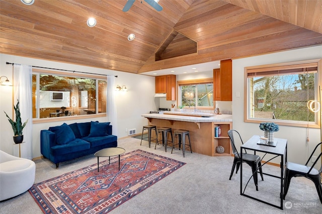 living room with high vaulted ceiling, wooden ceiling, light carpet, and ceiling fan