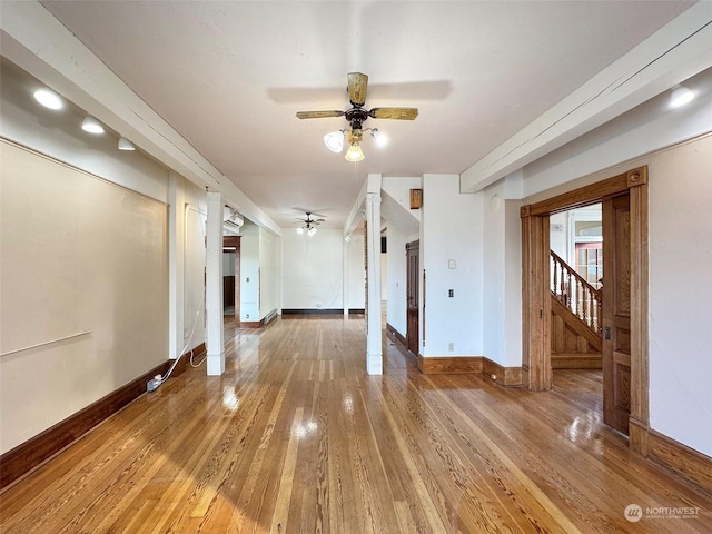 unfurnished room with ceiling fan and wood-type flooring