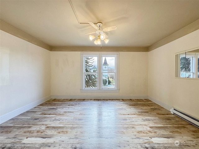 spare room with a baseboard radiator, ceiling fan, and light wood-type flooring