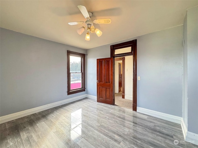 unfurnished bedroom with ceiling fan and light wood-type flooring