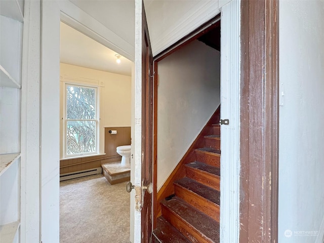 stairway featuring a baseboard radiator and carpet floors