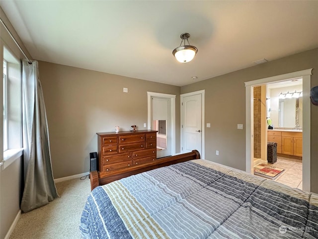 carpeted bedroom featuring ensuite bathroom