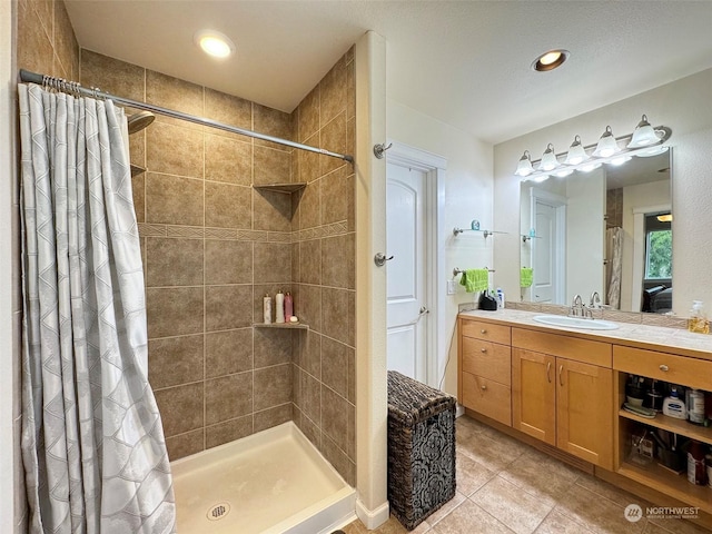 bathroom with tile patterned floors, a shower with shower curtain, and vanity