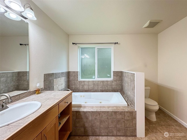 bathroom with toilet, a relaxing tiled tub, tile patterned floors, and vanity