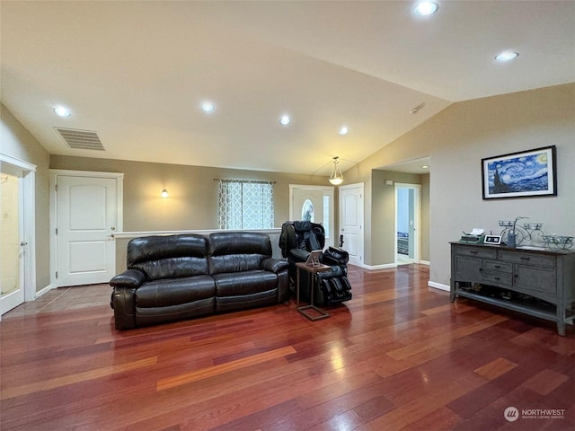 living room featuring lofted ceiling and dark hardwood / wood-style flooring