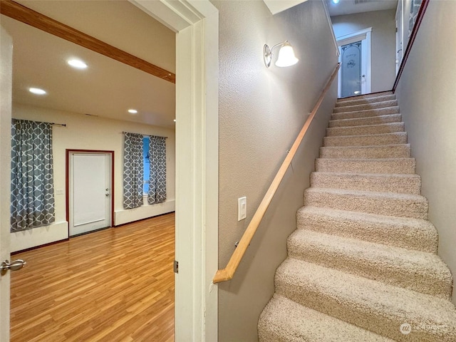 staircase with wood-type flooring