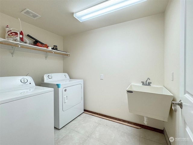 laundry room with washing machine and dryer and sink