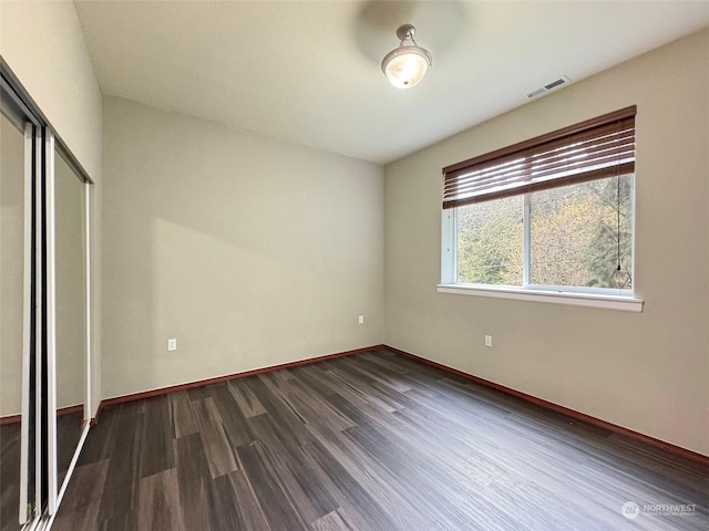 unfurnished bedroom featuring dark wood-type flooring