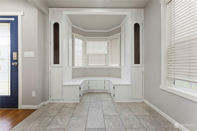 tiled entrance foyer featuring ornamental molding