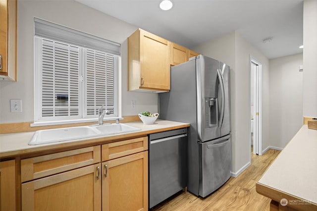 kitchen featuring sink, stainless steel appliances, light hardwood / wood-style floors, and light brown cabinetry