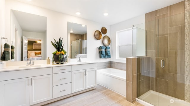 bathroom featuring plus walk in shower and vanity