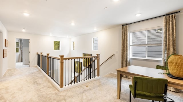 hall with plenty of natural light and light colored carpet