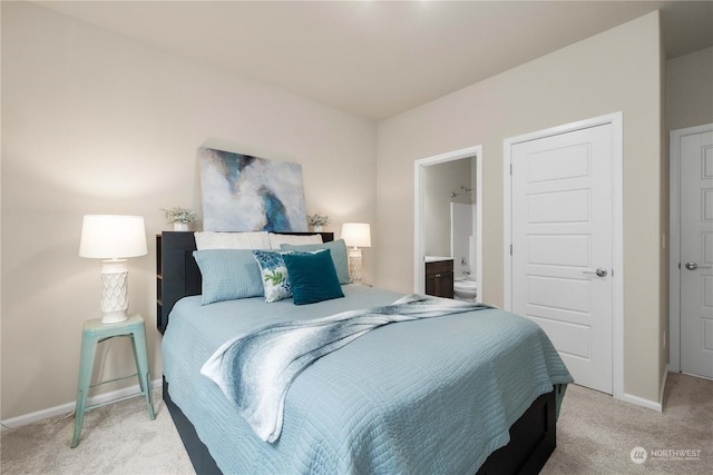 carpeted bedroom featuring ensuite bathroom