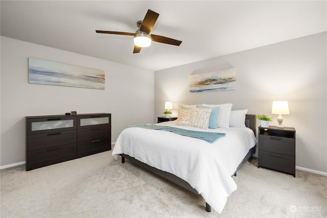 bedroom with ceiling fan and light carpet