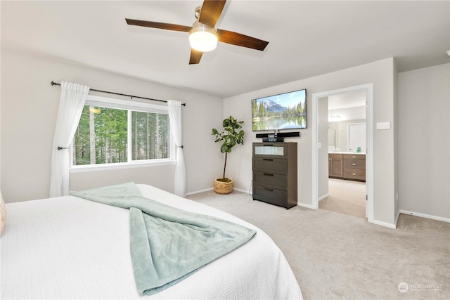 carpeted bedroom featuring ceiling fan and connected bathroom