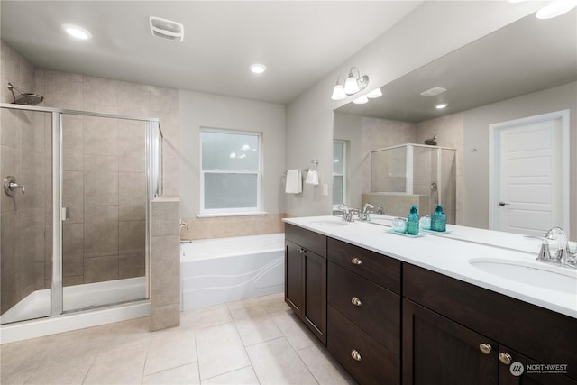 bathroom featuring vanity, tile patterned flooring, and separate shower and tub