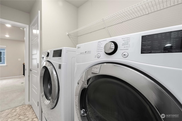 laundry area with light colored carpet and washing machine and clothes dryer