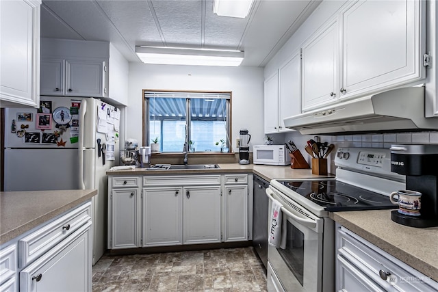 kitchen featuring white appliances, sink, and white cabinets