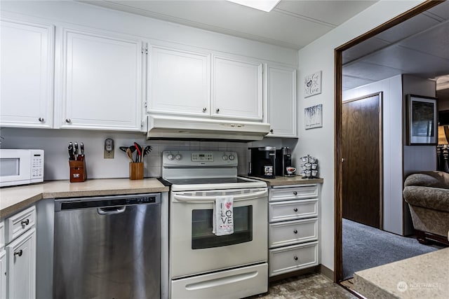 kitchen with backsplash, white appliances, and white cabinets