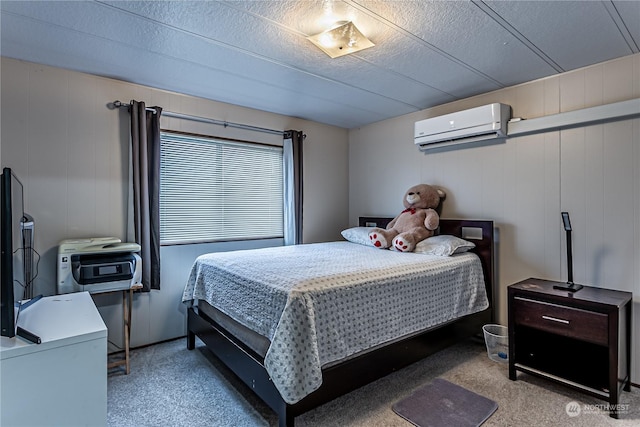 carpeted bedroom featuring wooden walls, a wall unit AC, and a textured ceiling