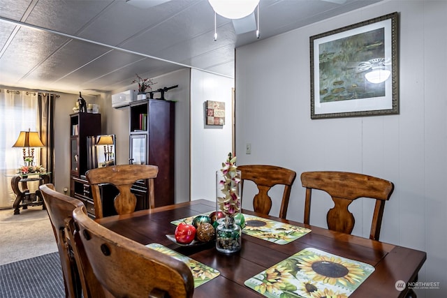 carpeted dining room with an AC wall unit