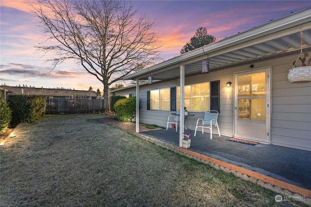 yard at dusk with a patio area