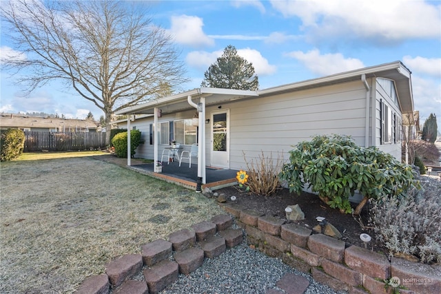 back of house featuring a yard and a patio area