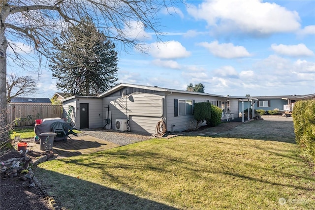 back of house featuring a yard and ac unit