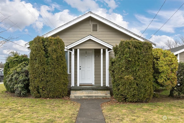 bungalow-style house with a front yard