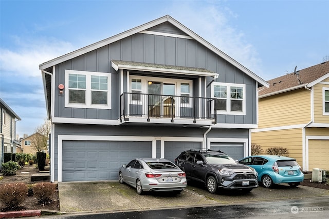 view of front of property featuring a balcony and a garage