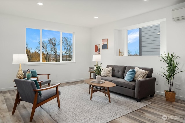 living room featuring a wall mounted AC and light wood-type flooring