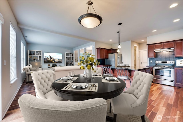 dining space with dark hardwood / wood-style flooring