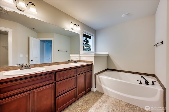 bathroom with vanity and a bathtub