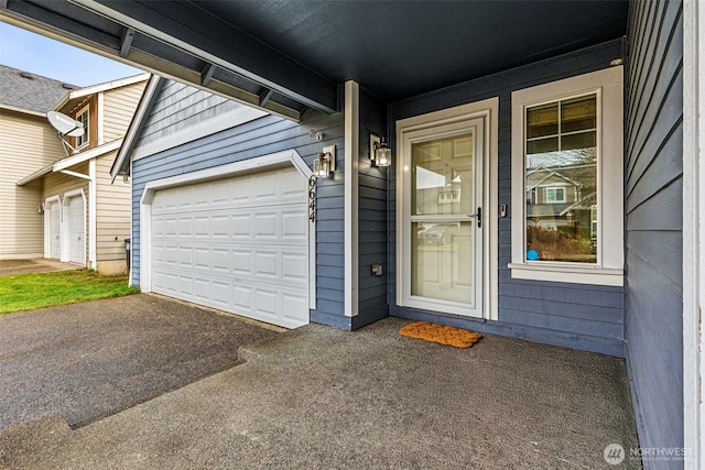 doorway to property with a garage