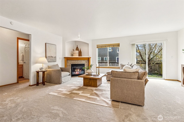 living room with light carpet and a tiled fireplace