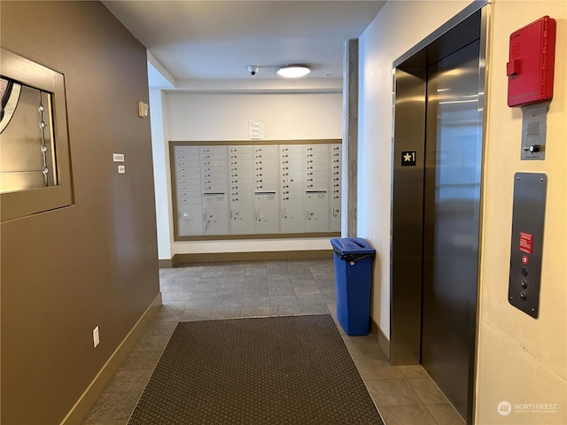 hall with tile patterned flooring, elevator, and mail boxes