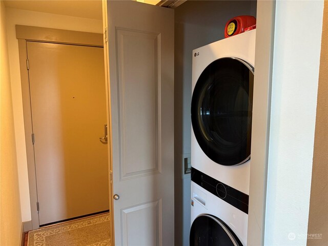 laundry room with stacked washer / drying machine