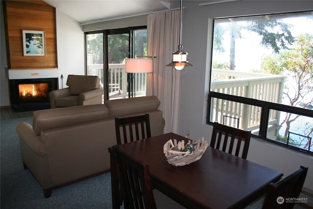 carpeted dining room featuring vaulted ceiling