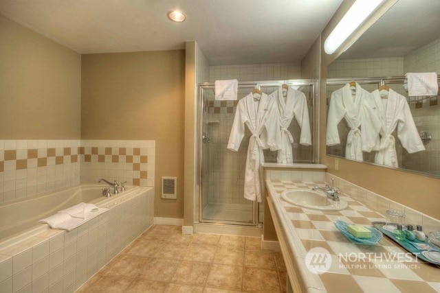 bathroom with vanity, separate shower and tub, and tile patterned flooring