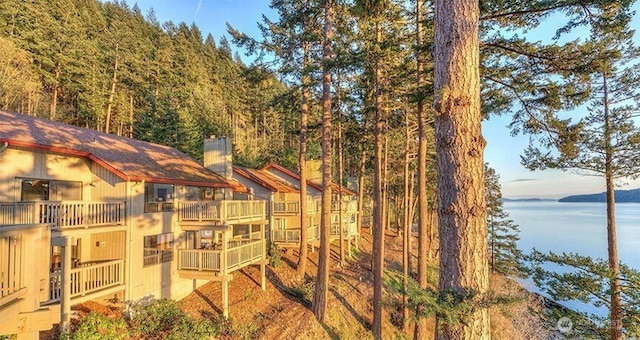 exterior space with a balcony and a water view