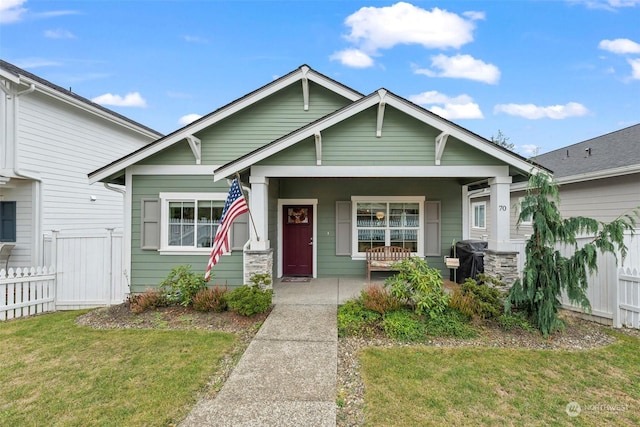 view of front of house with a porch and a front yard