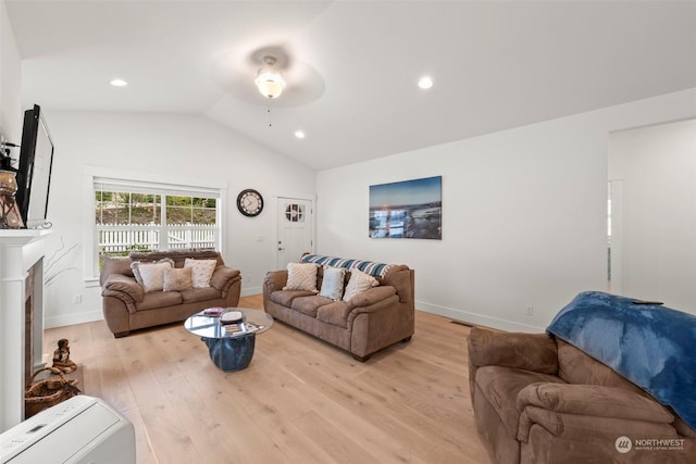 living room with lofted ceiling, light wood-type flooring, and ceiling fan