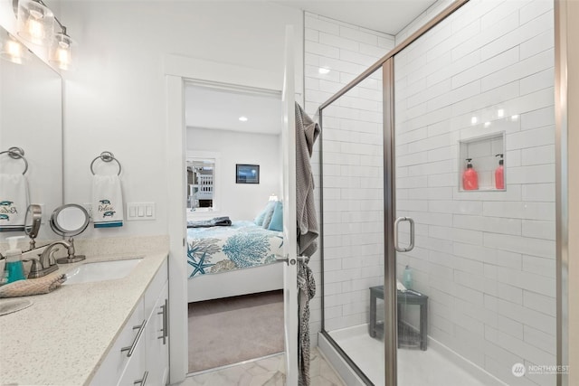 bathroom featuring an enclosed shower and vanity