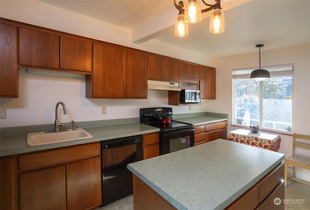 kitchen with black appliances, pendant lighting, a kitchen island, and sink