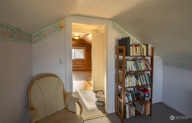 sitting room featuring light colored carpet and lofted ceiling