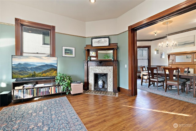 living area featuring hardwood / wood-style floors and an inviting chandelier