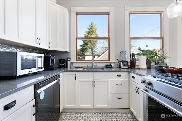 kitchen featuring sink, white cabinets, and appliances with stainless steel finishes